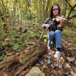 andi leahy black haired woman playing fiddle violin in forest